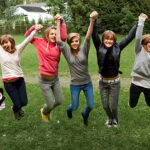 Teenage girls jumping: